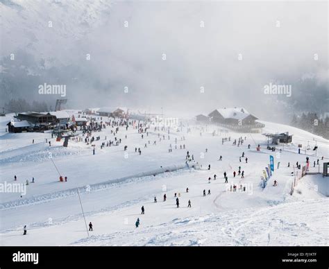 Panorama delle Alpi Bavaresi innevate con sciatori sulle piste