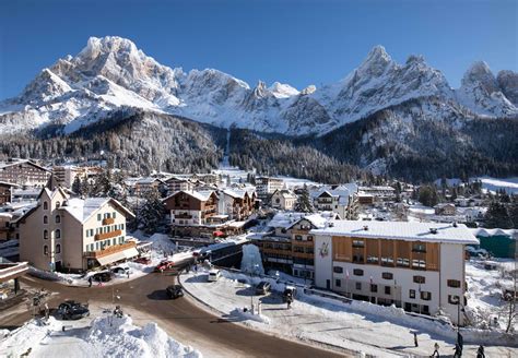 Famiglia che scia insieme a San Martino di Castrozza con vista sulle Dolomiti