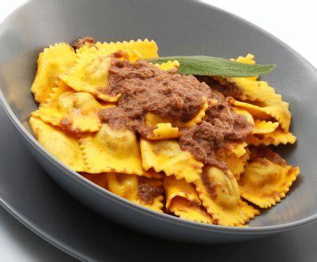 Illustrazione di un piatto tradizionale piemontese, come gli agnolotti al brasato, servito in un ristorante rustico.