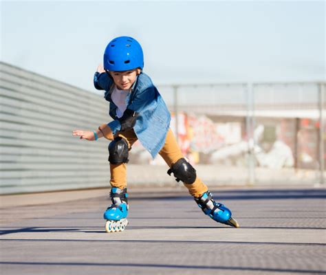 Bambini che imparano a pattinare su rotelle sotto la supervisione di un istruttore.