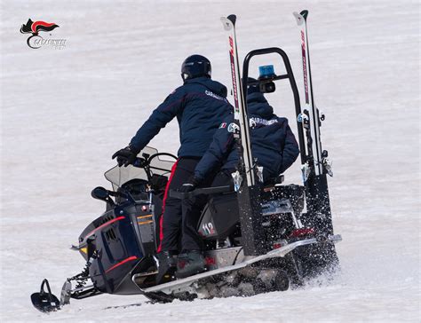 Motoslitta dei Carabinieri in azione su un pendio innevato.