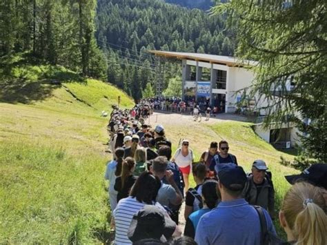Persone in coda per salire sulla funivia in una località di montagna