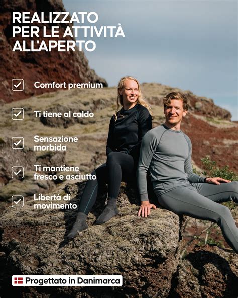 Uomo con abbigliamento termico da sci completo, sorridente e pronto per la pista