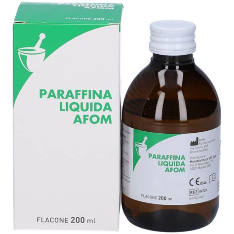 Immagine di un flacone di paraffina liquida TOKO World Cup con uno sci da gara in primo piano