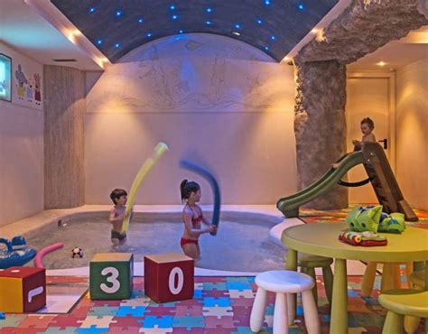 Interno di un hotel per famiglie con area giochi e personale che assiste i bambini
