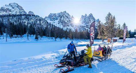 paesaggio dolomitico con motoslitta in primo piano