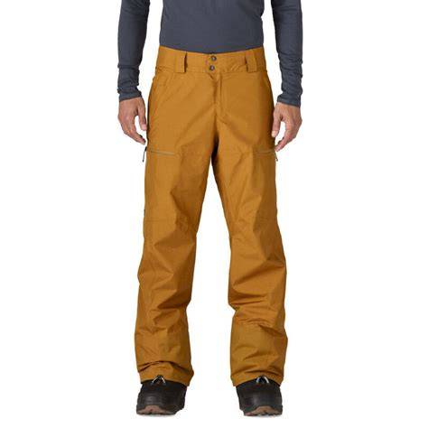 Modello di pantaloni da sci marroni da uomo con dettagli tecnici in primo piano