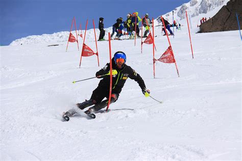 A skier navigating a tightly spaced series of gates in a slalom race.